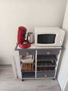 a kitchen cart with a microwave and a mixer at MAISON BISCARROSSE LAC 6 pers in Biscarrosse