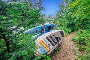 a boat sitting on a trail in the woods at Spa & River - Le Saint-Gabriel in Saint-Gabriel-De-Valcartier