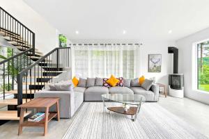 a living room with a couch and a table at Spa & River - Le Saint-Gabriel in Saint-Gabriel-De-Valcartier