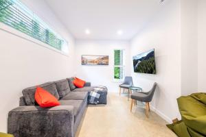 a living room with a couch and a table at Spa & River - Le Saint-Gabriel in Saint-Gabriel-De-Valcartier +76 photos