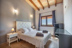a bedroom with a large bed and a television at Los tres soles in Portocolom +35 photos