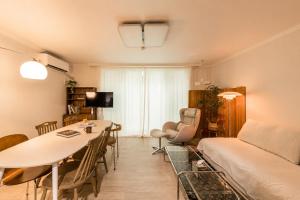 a living room with a couch and a dining room at 수지의 하우스 in Cheonan
