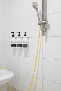 a shower with a hose in a bathroom at 수지의 하우스 in Cheonan