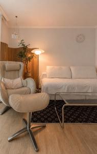 a bedroom with a bed and a chair and a table at 수지의 하우스 in Cheonan