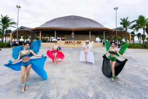 a group of women standing on the beach with umbrellas at Regal Collection Hotels & Suite in Dương Cảnh +128 photos