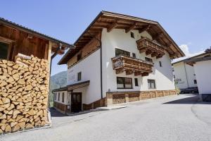 a building with a pile of fire wood next to it at Appartements Belledonne Ski & Bike in and out, zentrale Lage in Sölden