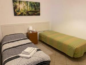 a room with two beds and a picture on the wall at Casa Tanina in Scordia