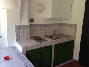 a small kitchen with a sink and a stove at JERA Holiday Collection VULCANO UNO - Garden View in Vulcano