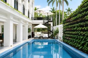 a swimming pool in the middle of a building at THE RIVERFRONT CENTRAL Hotel in Siem Reap