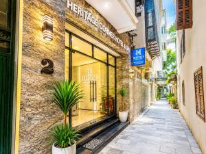 a building with a store window on a street at Emissary Corner Hanoi Hotel & Spa in Hanoi
