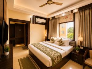 a hotel room with a bed and a window at Hotel Ramawati Near Ganga Ghat, Haridwar in Haridwār
