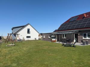 a backyard with solar panels on the roof of a house at Friese24 in Wangerland