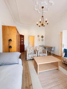 a living room with a couch and a table at Dinnyés Kúria Dabas in Dabas