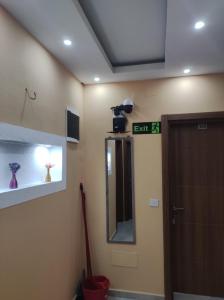 a bathroom with a door and a mirror and a camera at Grandino rooms & apartments in Ulcinj