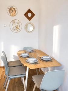 a dining room with a wooden table and chairs at Dinnyés Kúria Dabas in Dabas
