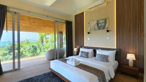 a bedroom with two beds and a large window at Villa Monsoon in Nathon Bay +124 photos