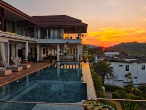 a villa with a swimming pool at sunset at Villa Monsoon in Nathon Bay