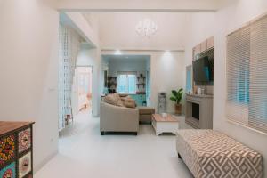a living room with a couch and a table at Suka Village 