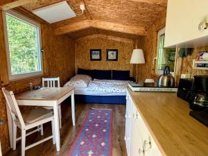 a bedroom with a bed and a table and a kitchen at Sonnenhof Uckermark in Lübbenow +103 photos