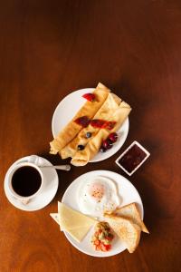 two white plates of food and a cup of coffee at Sea Tide by Jade Rock in Negombo