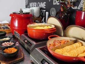 a counter top with a stove with dishes of food at ibis Barranquilla in Barranquilla