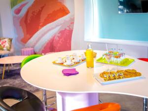 a table with two plates of food and drinks on it at ibis Styles Fréjus St Raphael in Fréjus