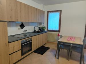 a kitchen with a table and a dining room at Dolce casa in Saone