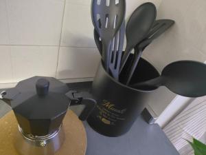 a cup filled with utensils sitting on a counter at Dolce casa in Saone