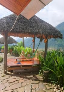 a hammock under a large umbrella on a deck at D&D Eco Sapa in Sapa
