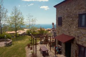 a balcony of a house with a view of the ocean at Il Ritrovo degli Angeli in San Mauro Cilento