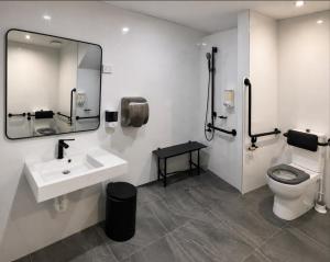 a bathroom with a sink and a toilet and a mirror at Paradise Pods in Gold Coast +14 photos