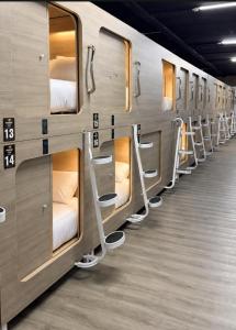 a row of bunk beds on a subway train at Paradise Pods in Gold Coast