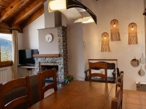 a dining room with a table and a fireplace at Casa Jonico in Montardit +36 photos