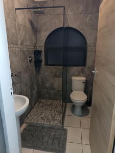 a bathroom with a toilet and a sink at Summer Place 12 in Shelly Beach