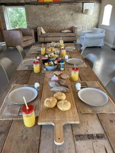 a long wooden table with plates and food on it at Hofstede Boterhoek in Scharendijke +10 photos