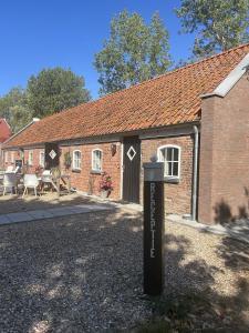 a sign in front of a brick house at Hofstede Boterhoek in Scharendijke