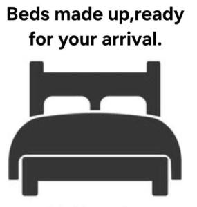 a picture of a bed with a bed made up ready for your arrival at Sally Chalet in Hemsby