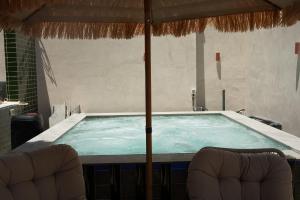 a table with two chairs and an umbrella at Lumi Hotel Eilat - מלון בוטיק באילת in Eilat