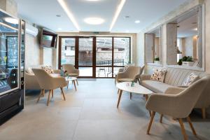 a waiting room with couches and tables and a tv at Tarnovka - Guest Rooms in Veliko Tŭrnovo