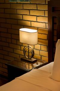 a lamp on a table next to a bed at Platan in Samarkand +12 photos