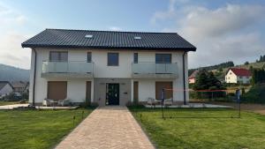 a large white house with at Apartamenty Polna Ostoja in Tylicz