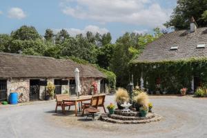 a table and chairs in front of a building at Mrs Delaney's Loft in Ardfinnan