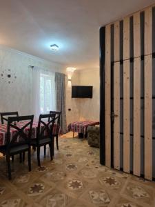 a living room with two chairs and a table and a bedroom at Madoyans Rest House in Antarut