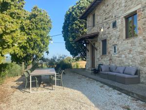 a couch and a table in front of a building at Colle Costanza in Todi