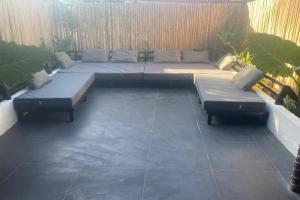 a patio with two couches and sidx sidx sidx sidx at Angelito's Beach House Siargao near Beach in General Luna