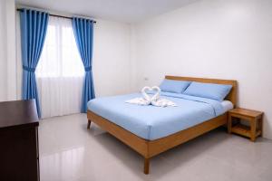 a bedroom with a bed with a white towel on it at Angelito's Beach House Siargao near Beach in General Luna