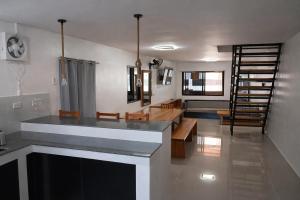 a kitchen and living room with a counter and a staircase at Angelito's Beach House Siargao near Beach in General Luna +50 photos