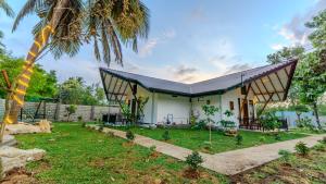 a house with a gambrel roof at Akash Treehouse in Sigiriya
