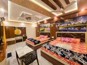 a room with two beds and a table in it at Lokenath Resort in Tarapith +81 photos