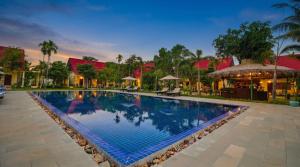 a swimming pool at a resort at night at Habana Angkor Resort in Siem Reap